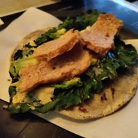 Chicharrón on top of a fried leaf taco at Malportaco in Mexico City