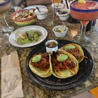 Vegan Al Pastor tacos, chips & guacamole, strawberry margarita (right), tamarindo margarita (left), salsa trio  at Casa Tequila in Cancun