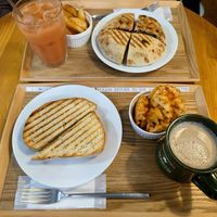 Top: pita sandwich, pressed with fries and guava juice. Bottom: German sauerkraut, vegan ham and pickles sandwich with mesh fries and chai latte at Falafel Brothers - Minato in Tokyo