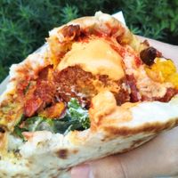 Completely forgot to take a photo before taking a bite! That's how good it was (toppings - tomato & cucumber, spicy peppers and pumpkin cabocha cha cha cha w/ spicy hini sauce) at Falafel Brothers - Minato in Tokyo