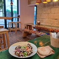 Interior and 'assiette' dish with falafel, hummus, veggies, and pita at Green Lab in Montpellier