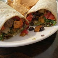 Burrito contained black beans, onion, red pepper, sweet potato, and kale. Added avocado.  at The Hoot in Northport