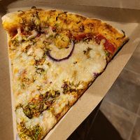 Red onion Brussels pizza slice at Whole Foods Market in Cedar Park