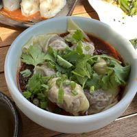 Chili Oil Wontons: vegan pork dumplings in our infamous sweet and tangy chili oil sauce  at Jade Rabbit in Portland