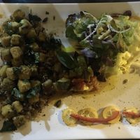 Stirred tofu with truffle oil, served with cooked mixed grain, ratatouille and salad at A Casa Leca in Ajaccio