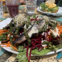 Mushroom pesto salad and açai smoothie. (Smashed Avo on toast with egg in background)  at Scallywags Cafe in Magnetic Island