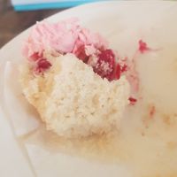 Half eaten raspberry cupcake at Becky's Scilly Cakes in Isle Of Scilly