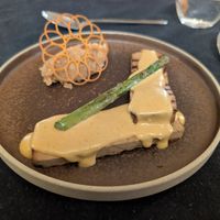 Tofu topped with peanut sauce and a side of white bean at Casa Albets in Lladurs