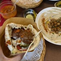 Falafel pita sandwich ( whole) the filling: falafels, hummus, salad, pickles (and added extra hummus from the plate & hot sauce) at Falafel TLV in Hong Kong Island