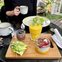 Vegan lunch: mango smoothie, avocado toast, chia seed pudding, and a chocolate mousse. My drink was a special coconut coffee they make.  at Spiregarden in Kristiansand