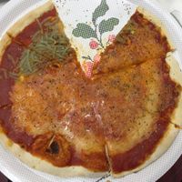 Three kinds of cheese pizza at Pizzeria La Faina in Malaga