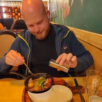 My boyfriend happy eating saltado at Chia Vegan Restaurant in Cusco