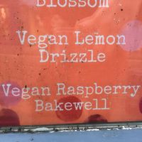 Vegan cakes listed in window at The Origami Cafe & Gift Shop in Alnwick