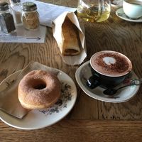I got a donut, a sausie roll, and a hot choc with oat milk. at Portershed in Christchurch