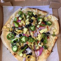 Loaded pizza with vegan cheese  at Cherokee Brewing + Pizza Company in Dalton