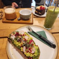 Avotoast and autumn matcha latte (with PB&J on banana bread in the background) at Coffee Room in Prague