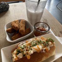 Seitan wings with dipping sauce, lobster roll, cherry milkshake partially drunk  at The Judgy Vegan in Brussels