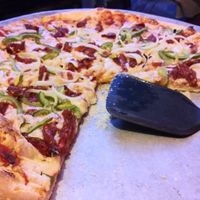 Sun dried tomatoes, onions, green peppers and non dairy cheese at The Brick Pizzeria in Columbus