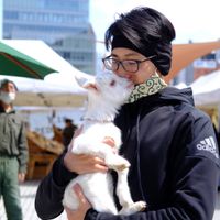 My husband holding a sweet baby goat. at Farmer's Market - UNU in Tokyo