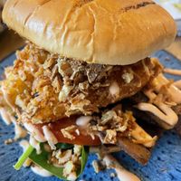 Hash brown stack in brioche burger   at No 18 Cafe in Swansea