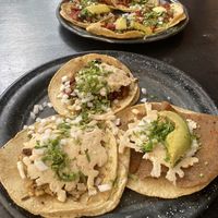 Al pastor tacos (background), chorizo roja taco, milanesa taco, and seitan al chimmichuri taco (all with added queso)  at Por Siempre Vegana Vol II in Mexico City