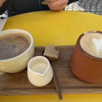 America with regular milk + cappuccino with coconut milk 💚 at Vero Caffe in Bruges