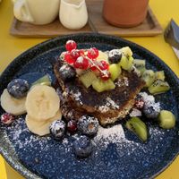 Vegan pancakes with maple syrup and fruits  at Vero Caffe in Bruges