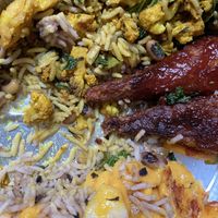 My delicious half-eaten vegan plate: BBQ drumsticks, mac-and-cheese, rice, black eyed peas, cauliflower at Veggie Castle in Jamaica