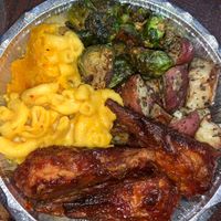 Mac and cheeze, drumsticks, potatoes, Brussel sprouts  at Veggie Castle in Jamaica