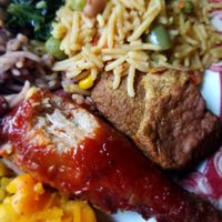 Love the chicken couldn't wait to eat it..lol hence the bite.. at Veggie Castle in Jamaica