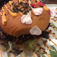 Close up of the burger with some petals on top of the bun. at The Organic Boho in Copenhagen