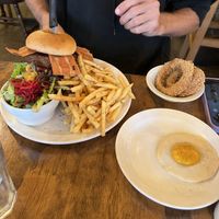 Apex burger, add onion rings and sunny side up egg  at Chickpea Restaurant in Vancouver