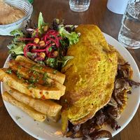 Breakfast Platter: Chickpea’s original Vegan Omelette with cheese, side salad, plus chickpea fries (for a little extra) at Chickpea Restaurant in Vancouver