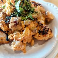 Roast cauli appetizer with harissa-spiced (not hot) tahini sauce and pistachios, delicious! at True Food Kitchen in King Of Prussia