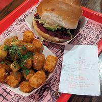 Poutine tots w tofu curds and vegan veggie burger at The Playhouse & Swillburger in Rochester