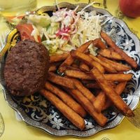 Beyond burger, sweet potato fries, salad with hummus dressing at Fari's in Ljubljana