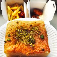 Vegan Persian baklava with vegan nuggets with vegan mayo and french fries with ketchup in the background. at Fari's in Ljubljana