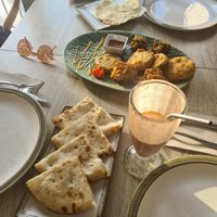 Cheese naan, mixed starters plate, papadam and some sauces at Spice Garden in Sitges