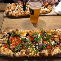 Best vegan pizza!! (The pizza in the background is not vegan) at Pizzatopia in Krakow