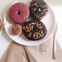 Chai and walnut, chocolate and berries, chocolate pretzel and a cinnamon ball at Donut Shop in Prague