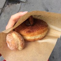 Avocado, banana and chocolate donut with small ball.  at Donut Shop in Prague