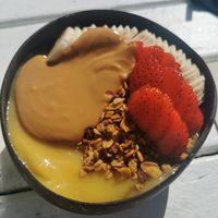 Mango smoothie bowl with almond butter at Nalu Bowls in Ericeira