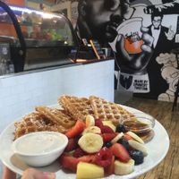 Waffles with fruit, syrup, and coconut cream. at Waffle on Cairns in Cairns