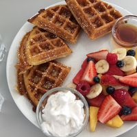 Freshly cut fruit salad, coconut yoghurt and vegan waffles at Waffle on Cairns in Cairns