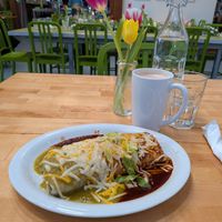 Smothered vegan Breakfast Burrito, with Christmas salsa and vegan cheese. Mushroom mama tea latte. at Sweetwater Harvest Kitchen in Santa Fe