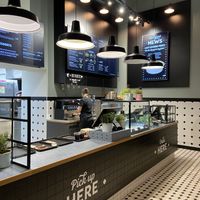Order and pick up counter with menu on digital display at Swing Kitchen - Kaiserfeldgasse in Graz