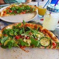 shared vegan pizza for two (each half served on two plats) at Pizzeria Gallus in Bled