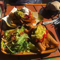 Vegan taquitos up front and vegan nachos in the background at Trippy Taco in Fitzroy