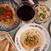Traditional hummus, roasted peppers hummus, pita and smoked cauliflower  at Tantura in Lisbon