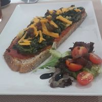 Tostada de espinacas con queso vegano. at El Secret in Falset